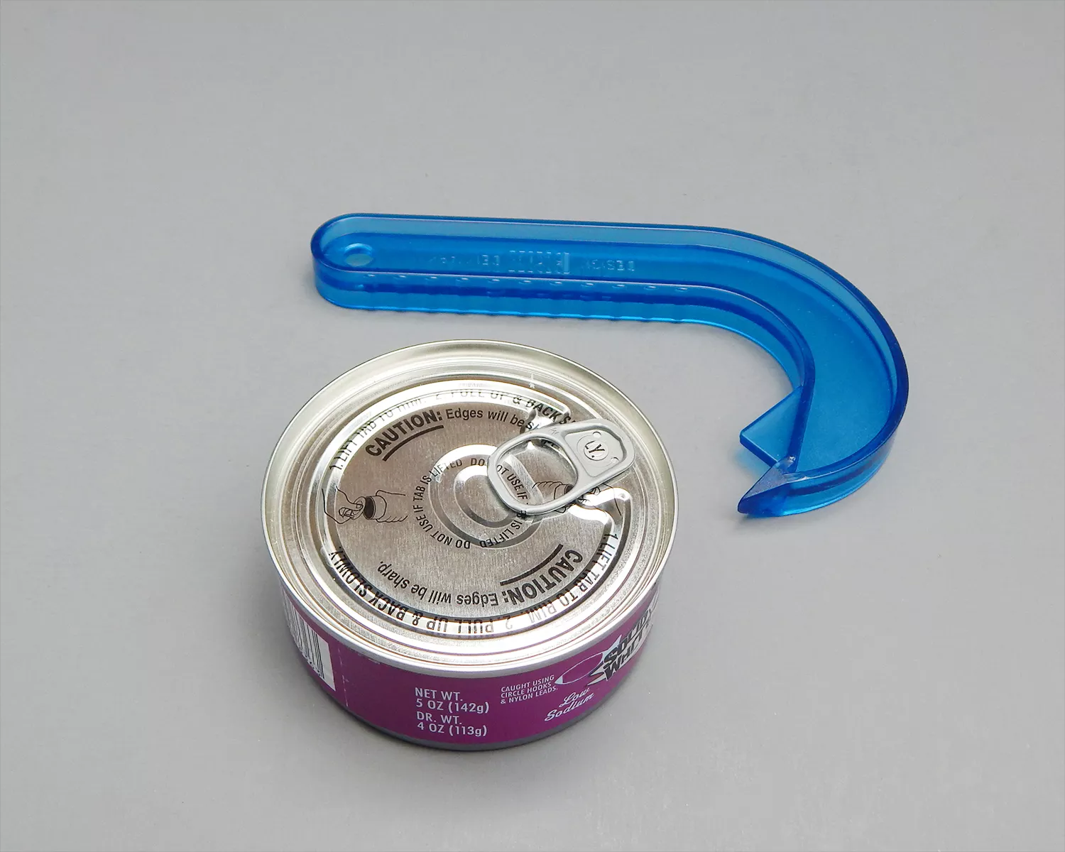 Brix Can Opener next to can of tuna